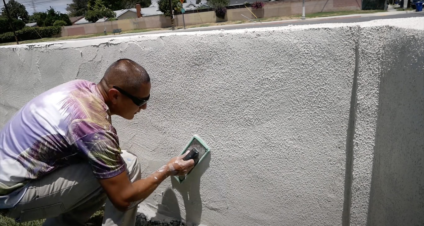 Professional concrete repair and restoration work on residential wall