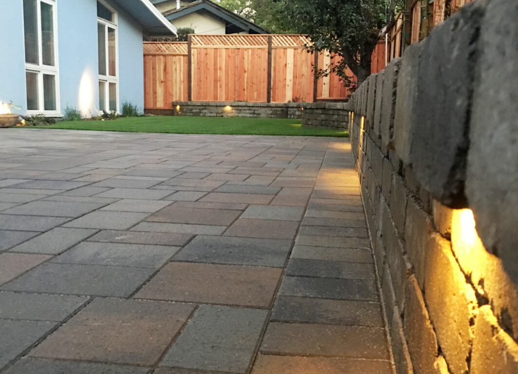 Beautiful stamped concrete patio with landscape lighting at dusk in Simi Valley